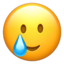 SMILING FACE WITH TEAR emoji in Apple's design style - Unicode 1F972